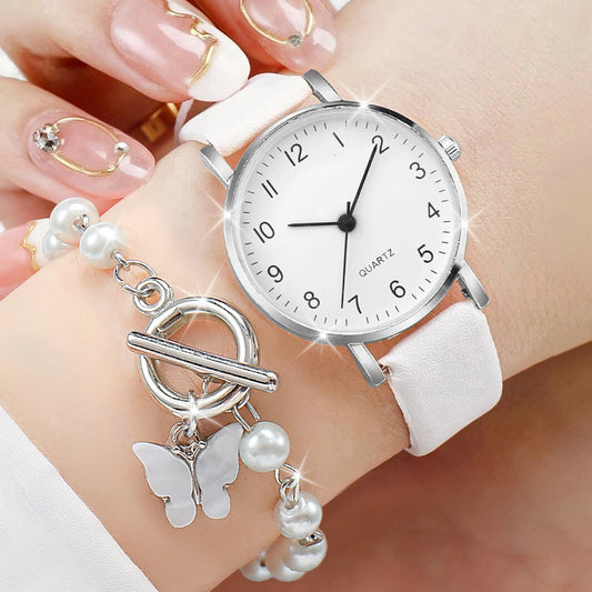 Leather bracelet watch with Arabic dial and pearls.